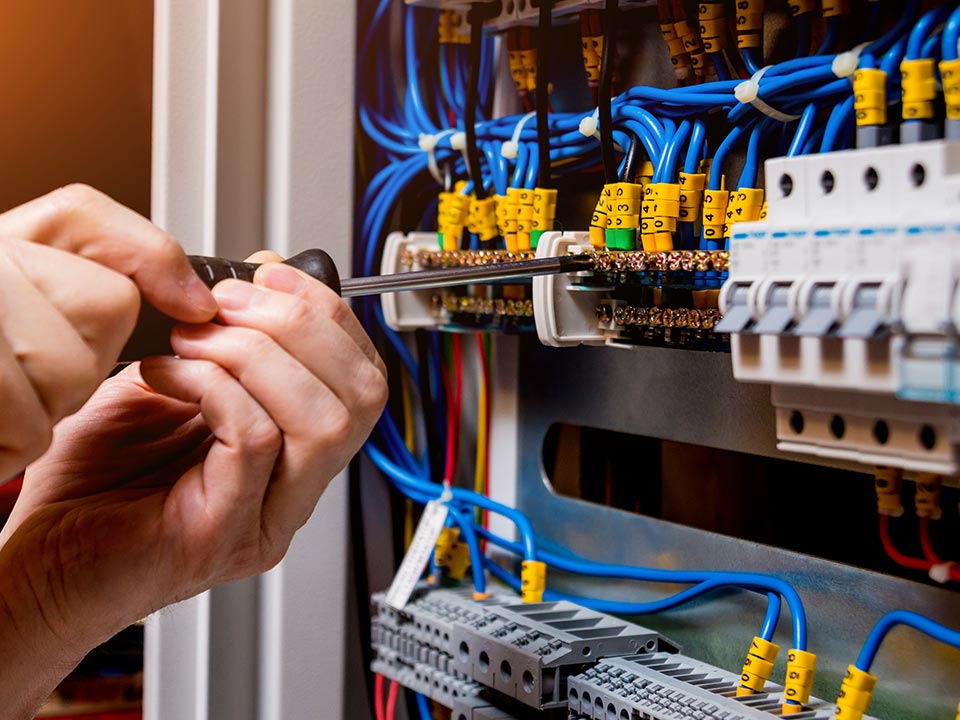 Electrician performing detailed switchboard wiring during electrical installation in Canberra